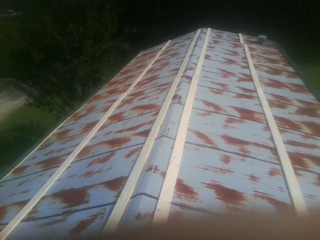 Rusted metal roof panels with new wood purlins before replacement — Storm Damage Roof Repair in Boiceville by Roofing Brothers
