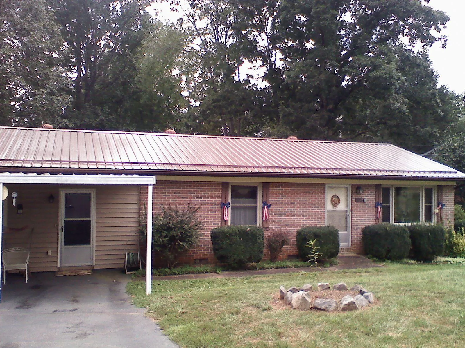 Bronze metal roof and carport on a brick ranch home — Roof Repair work by our crew in Boiceville
