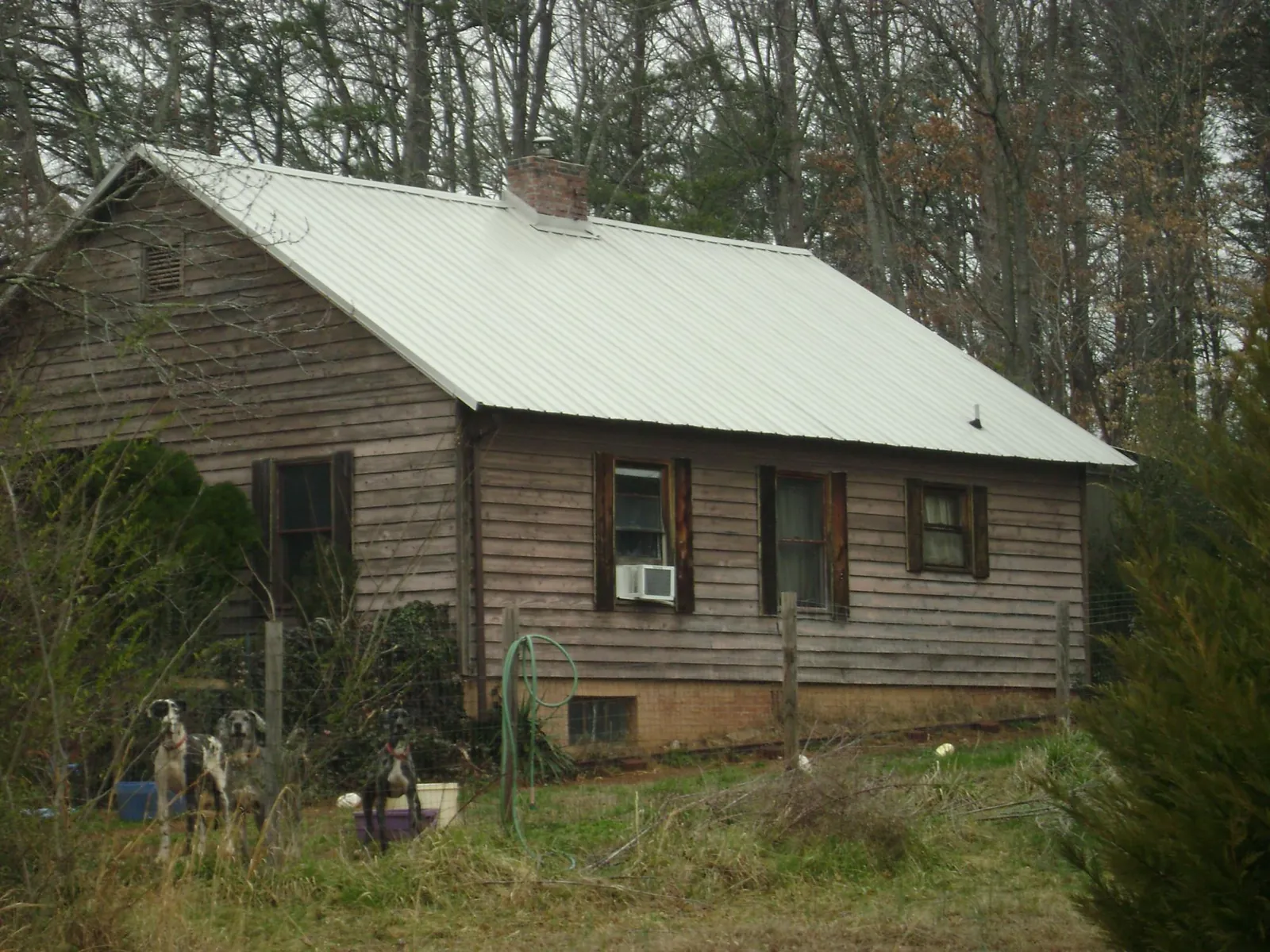 White metal roof on an old wood sided farmhouse, from a Metal Roof Installation job in Boiceville